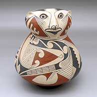 A Ramos polychrome figure decorated with a geometric design
 by Juan Quezada Sr of Mata Ortiz and Casas Grandes