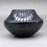 A black on black jar decorated with a band of feathers design above the shoulder, click or tap to see a larger version