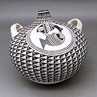 A large black on white canteen with handles and decorated with a crane and fish medallion surrounded by a spiral mesa geometric design
 by Grace Chino of Acoma