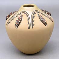 A polychrome jar decorated with five ear-of-corn appliques and a painted  five panel geometric design
 by Juanita Fragua of Jemez