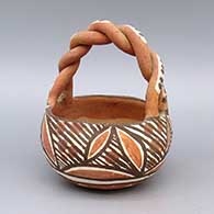 Polychrome friendship basket with twisted handle and geometric design
 by Unknown of Isleta