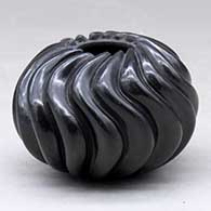 A polished black melon jar carved with 16 ribs
 by Nancy Youngblood of Santa Clara