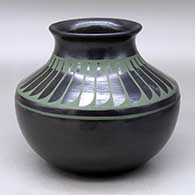 A green on black jar with a recurved neck and decorated above the shoulder with a ring of feathers design
 by Martha Appleleaf of San Ildefonso