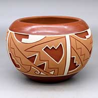 A polychrome Potsuwii-style bowl decorated with a four-panel painted and carved geometric design around the body
 by Rosita de Herrera of Ohkay Owingeh
