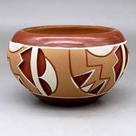 A polychrome Potsuwii-style bowl decorated with a four-panel painted and carved geometric design around the body
 by Rosita de Herrera of Ohkay Owingeh