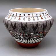 A polychrome jar decorated with a fineline, feather, pueblo dancer and geometric design
 by Rebecca Lucario of Acoma