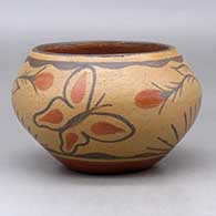 A polychrome bowl decorated with a two panel butterfly, flower, plant and geometric design
 by Unknown of San Ildefonso