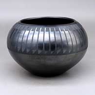 A black on gunmetal black jar decorated with a ring of feathers design above the shoulder
 by Maria Martinez of San Ildefonso
