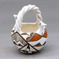 A polychrome bird basket with a twisted handle and decorated with a geometric design
 by Grace Lewis of Acoma