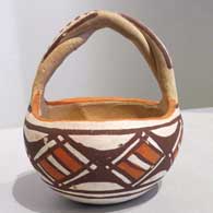 Polychrome friendship basket with twisted handle and geometric design 
 by Unknown of Isleta