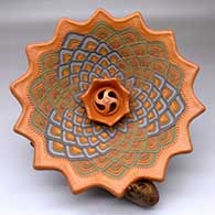 A shallow lazy coil polychrome bowl with a pie crust rim and decorated with a geometric design and a crown applique in the center with a sculptural center, on a custom driftwood stand
 by Jamie Zane Smith of Wyandot