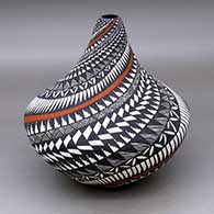 A polychrome tear drop jar decorated with a spiral feather, fineline, kiva step and geometric design
 by Sandra Victorino of Acoma