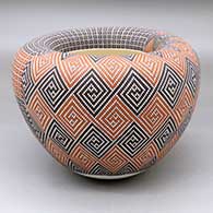 A polychrome jar with an Infinity rim and decorated with a two panel geometric tiny square design
 by Frederica Antonio of Acoma