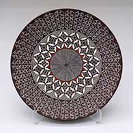 A polychrome plate decorated with a North Star fineline and geometric design
 by Rebecca Lucario of Acoma