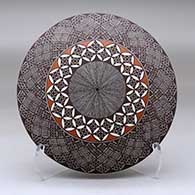 A polychrome seed pot decorated above the shoulder with a North Star fineline and geometric design
 by Rebecca Lucario of Acoma