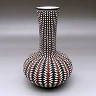 A tall neck polychrome vase decorated with a geometric design
 by Paula Estevan of Acoma