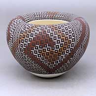 A polychrome jar with an infinity rim and decorated with a four-panel geometric design built of filling in tiny squares in a grid
 by Frederica Antonio of Acoma