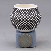 A miniature black on white jar decorated with a checkerboard geometric design
 by Frederica Antonio of Acoma