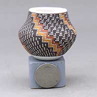 Click for a larger view A miniature polychrome jar decorated with a geometric design built of tiny squares
by Frederica Antonio of Acoma