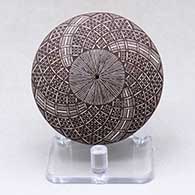 Click for a larger view A black on white seed pot decorated with a North Star fineline and geometric design above the shoulder
by Rebecca Lucario of Acoma