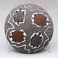 A polychrome seed pot decorated with a fineline, turtle and geometric design above the shoulder
 by Rebecca Lucario of Acoma