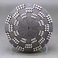 A black on white seed pot decorated with a North Star fineline and geometric design above the shoulder
 by Rebecca Lucario of Acoma