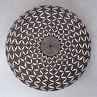 A black on white seed pot decorated with a yucca leaf snowflake, North Star fineline and geometric design
 by Rebecca Lucario of Acoma