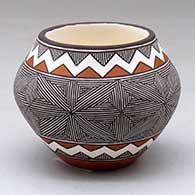 A small polychrome jar decorated with a snowflake fineline and geometric design
 by Rebecca Lucario of Acoma