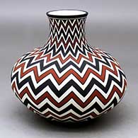 A polychrome jar with a short neck and decorated around the whole with a lightning bolt geometric design
 by Paula Estevan of Acoma