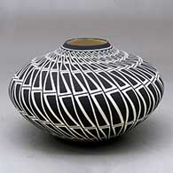 A black on white jar with a raised rim and decorated with a geometric design
 by Paula Estevan of Acoma