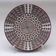 A polychrome plate decorated with a North Star, fineline and geometric design
 by Amanda Lucario of Acoma