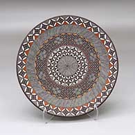 A polychrome plate decorated with a North Star, fineline and geometric design
 by Rebecca Lucario of Acoma