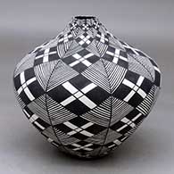 Click for a larger view A high-shouldered black on white jar decorated with a stylized checkerboard, fineline and geometric design
by Sandra Victorino of Acoma