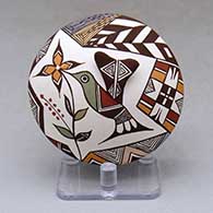 Click for a larger view A polychrome seed pot decorated with hummingbird wing and lady bug appliques and a hummingbird, flower and geometric design
by Carolyn Concho of Acoma