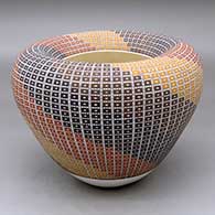 A polychrome jar with an Infinity rim and decorated with a geometric design built of tiny squares
 by Frederica Antonio of Acoma