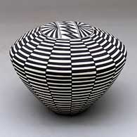 Click for a larger view A black on white seed pot decorated with a stylized checkerboard and geometric design
by Cletus Victorino of Acoma