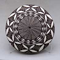 A black on white seed pot decorated above the shoulder with a yucca leaf snowflake, fineline and geometric design
 by Amanda Lucario of Acoma