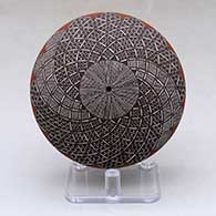 A polychrome seed pot decorated with a North Star fineline and geometric design above the shoulder
 by Rebecca Lucario of Acoma