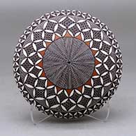 A polychrome seed pot decorated with a North Star fineline, yucca leaf snowflake and geometric design above the shoulder
 by Rebecca Lucario of Acoma