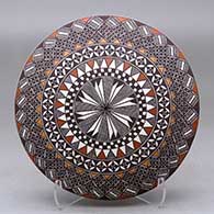 A polychrome seed pot decorated above the shoulder with a fineline and geometric design
 by Rebecca Lucario of Acoma