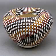 A polychrome jar with an Infinity rim and decorated with a stylized checkerboard and stripe geometric design
 by Frederica Antonio of Acoma
