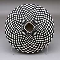 A black on white flat jar with a square neck and opening, decorated with a checkerboard design above and below
 by Paula Estevan of Acoma