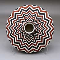 A polychrome flat jar with a short neck and decorated with a lightning bolt design above and below
 by Paula Estevan of Acoma