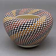 A polychrome jar with an Infinity rim and decorated with a spiral checkerboard geometric design
 by Frederica Antonio of Acoma
