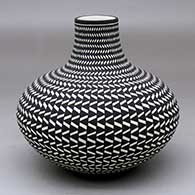 A black on white jar with a short neck decorated from top to bottom with a geometric design
 by Paula Estevan of Acoma