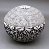 A black on white seed pot decorated with a fineline and geometric design
 by Cletus Victorino of Acoma
