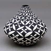 A black on white tear drop jar decorated with a pumpkin seed snowflake and geometric design
 by Sandra Victorino of Acoma