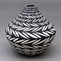 A black on white jar decorated with bands of geometric design
 by Sandra Victorino of Acoma