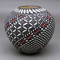 A polychrome jar decorated with a spiral checkerboard, pumpkin seed snowflake, fineline and geometric design
 by Sandra Victorino of Acoma