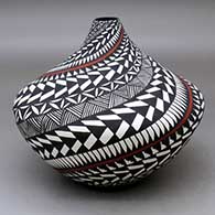 A large polychrome tear drop jar decorated with a spiral feather, fineline and geometric design
 by Sandra Victorino of Acoma